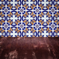 Image showing Wood table top and blur vintage ceramic tile pattern wall