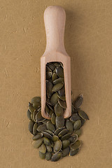 Image showing Wooden scoop with pumpkin seeds