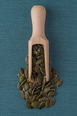 Image showing Wooden scoop with pumpkin seeds