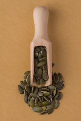 Image showing Wooden scoop with pumpkin seeds