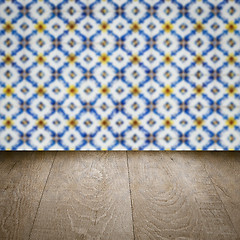 Image showing Wood table top and blur vintage ceramic tile pattern wall