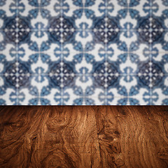 Image showing Wood table top and blur vintage ceramic tile pattern wall