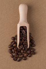 Image showing Wooden scoop with coffee beans