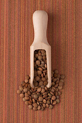 Image showing Wooden scoop with lentils