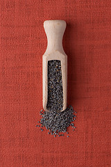 Image showing Wooden scoop with poppy seeds