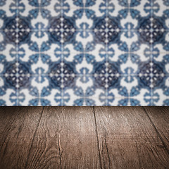 Image showing Wood table top and blur vintage ceramic tile pattern wall