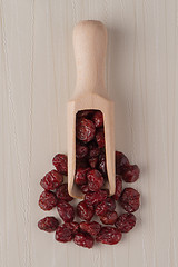 Image showing Wooden scoop with dried cranberries