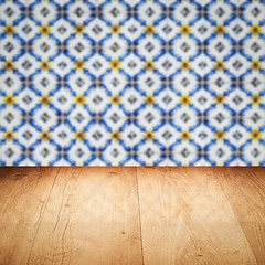 Image showing Wood table top and blur vintage ceramic tile pattern wall