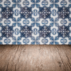 Image showing Wood table top and blur vintage ceramic tile pattern wall