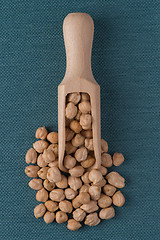 Image showing Wooden scoop with chickpeas