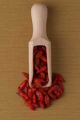 Image showing Wooden scoop with dry red goji berries