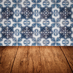 Image showing Wood table top and blur vintage ceramic tile pattern wall