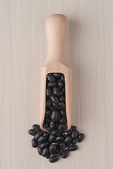 Image showing Wooden scoop with black beans