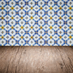 Image showing Wood table top and blur vintage ceramic tile pattern wall