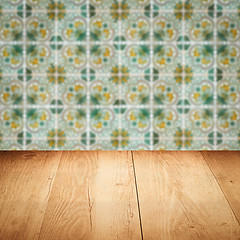 Image showing Wood table top and blur vintage ceramic tile pattern wall