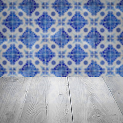 Image showing Wood table top and blur vintage ceramic tile pattern wall