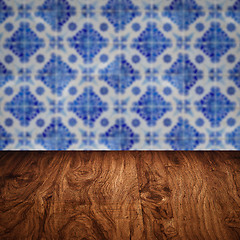 Image showing Wood table top and blur vintage ceramic tile pattern wall