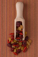 Image showing Wooden scoop with mixed dried fruits