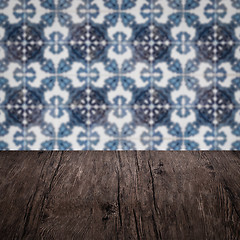 Image showing Wood table top and blur vintage ceramic tile pattern wall