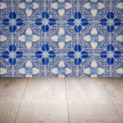 Image showing Wood table top and blur vintage ceramic tile pattern wall