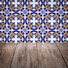 Image showing Wood table top and blur vintage ceramic tile pattern wall