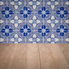 Image showing Wood table top and blur vintage ceramic tile pattern wall