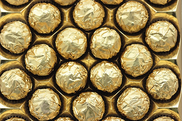 Image showing Chocolate sweets in golden foil