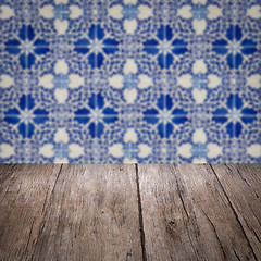 Image showing Wood table top and blur vintage ceramic tile pattern wall