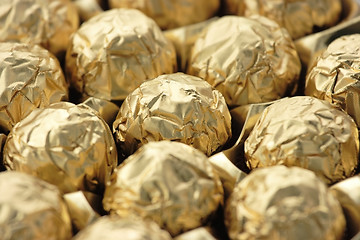 Image showing Chocolate sweets in golden foil
