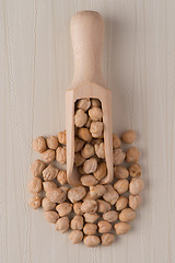 Image showing Wooden scoop with chickpeas