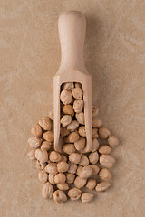 Image showing Wooden scoop with chickpeas