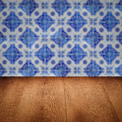 Image showing Wood table top and blur vintage ceramic tile pattern wall