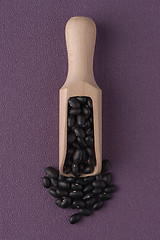 Image showing Wooden scoop with black beans