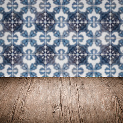 Image showing Wood table top and blur vintage ceramic tile pattern wall