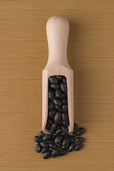 Image showing Wooden scoop with black beans