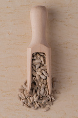 Image showing Wooden scoop with shelled sunflower seeds