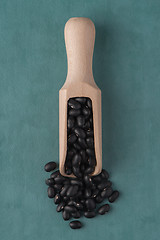 Image showing Wooden scoop with black beans