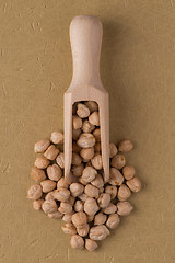 Image showing Wooden scoop with chickpeas