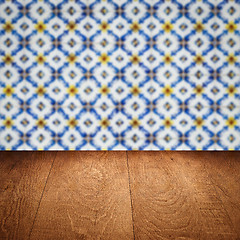 Image showing Wood table top and blur vintage ceramic tile pattern wall