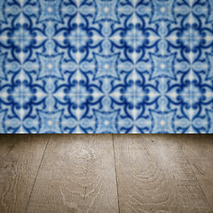 Image showing Wood table top and blur vintage ceramic tile pattern wall