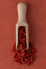 Image showing Wooden scoop with dry red goji berries