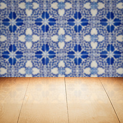 Image showing Wood table top and blur vintage ceramic tile pattern wall