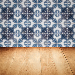 Image showing Wood table top and blur vintage ceramic tile pattern wall