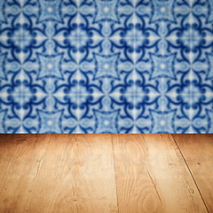 Image showing Wood table top and blur vintage ceramic tile pattern wall