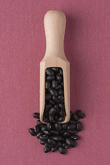 Image showing Wooden scoop with black beans