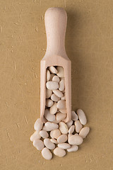 Image showing Wooden scoop with white beans