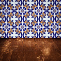 Image showing Wood table top and blur vintage ceramic tile pattern wall