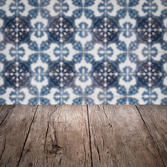 Image showing Wood table top and blur vintage ceramic tile pattern wall