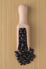 Image showing Wooden scoop with black beans