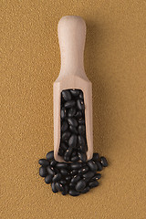 Image showing Wooden scoop with black beans